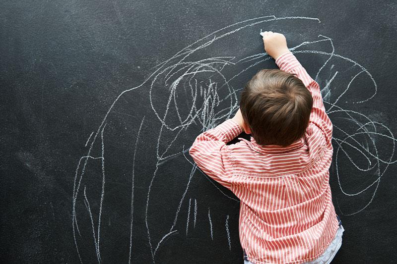 child at the chalkboard scribble